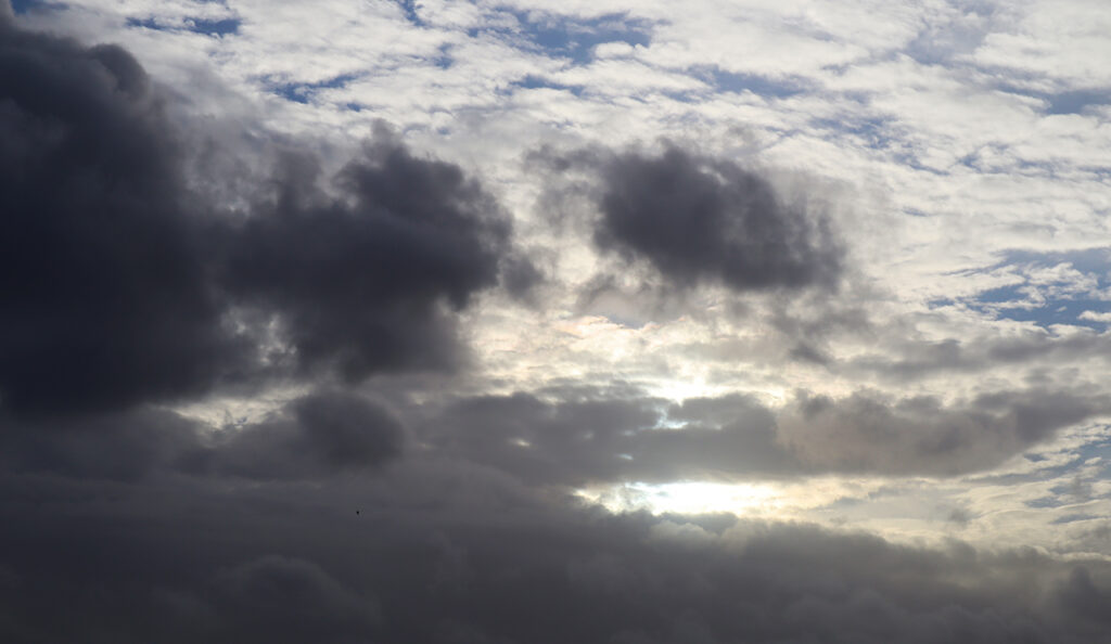 sunlight seen through dark clouds in the sky