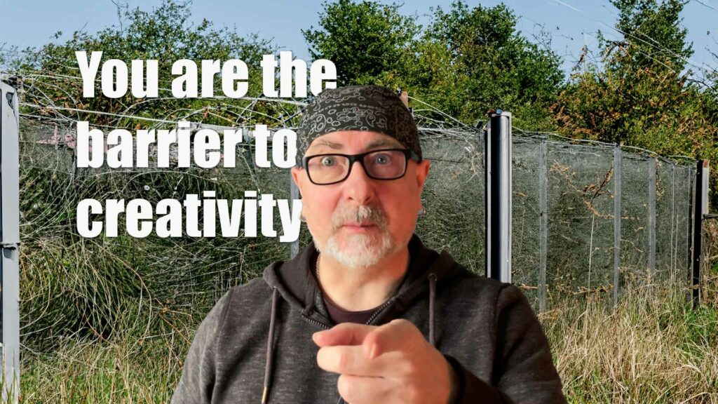 you are the barrier to creativity text and image or me in front of a fence with barbed wire